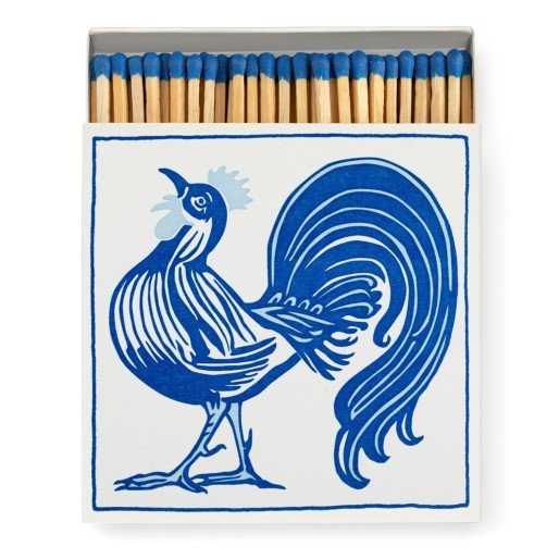 Blue tipped wooden safety matches popping out of the cockerel match box
