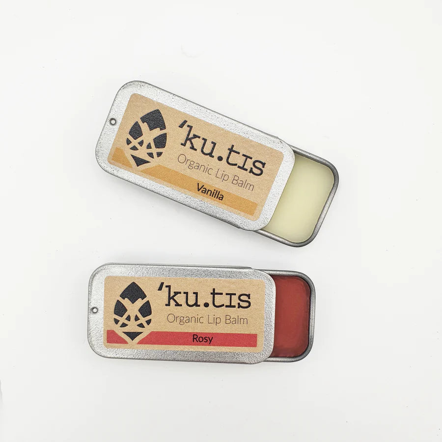 Kutis vanilla and rosy lip balms opened up on top of a table