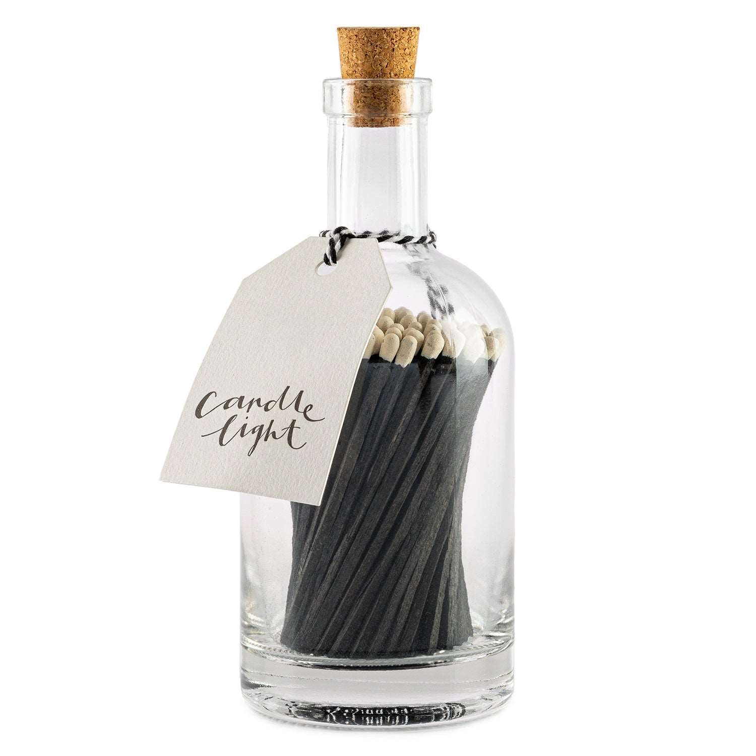 White tipped black wooden safety matches sat in a glass jar, labelled candle light.