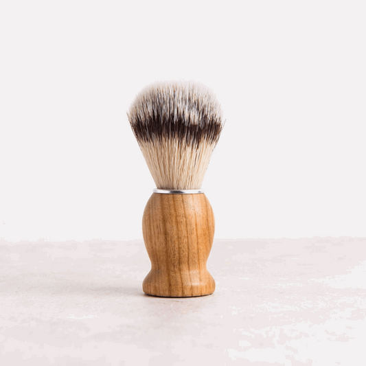 Wooden shaving brush on table